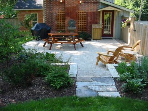 Shady patio made of English cobble with stone steps